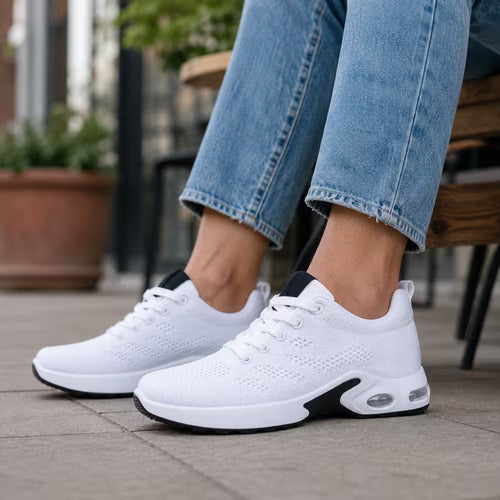 Pair of white knit lace-up sneakers with cushioned sole and air-cushion pod detail