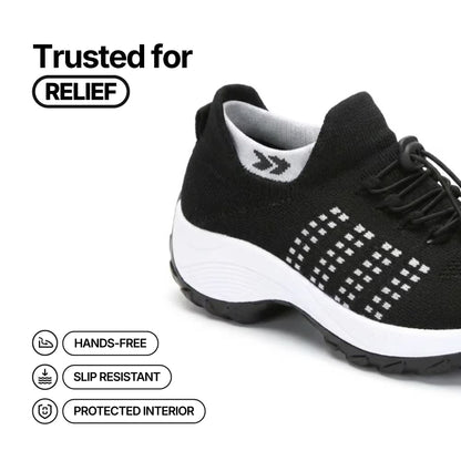 Black comfort sneaker with white dotted stripe, lace-up closure and thick sole