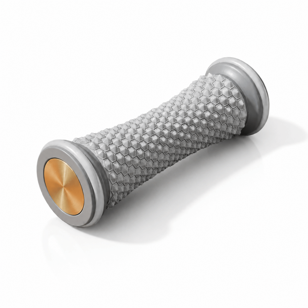 Gray foot massage roller with hex-textured surface and gold center end caps